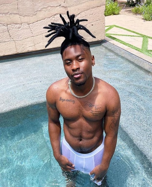 Edwig Henson has many tattoos on his chest