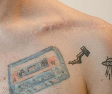 Joel Orta inked tattoo on his chest and arm