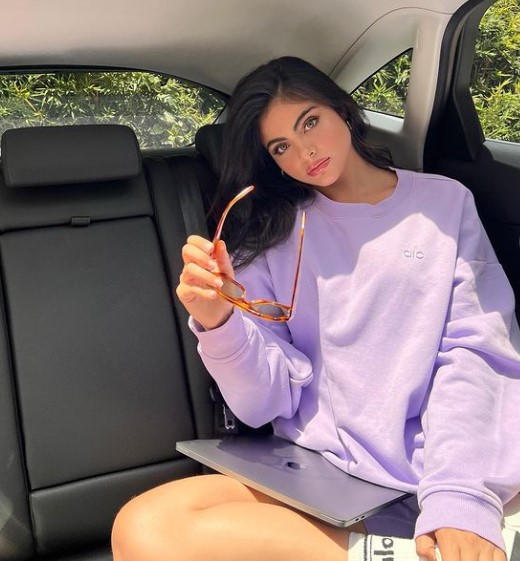Sara Orrego posing in her car