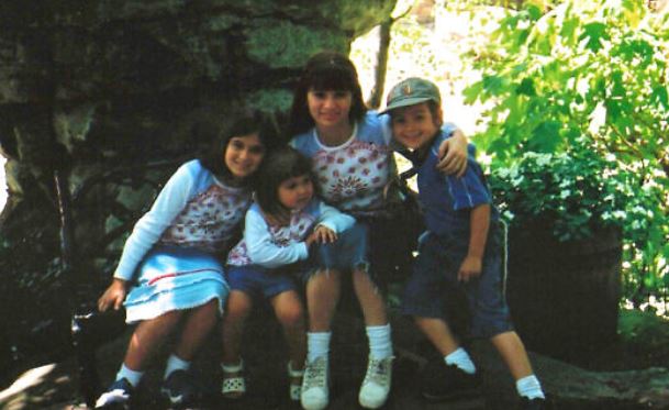 Childhood image of Miriam with her mom and siblings