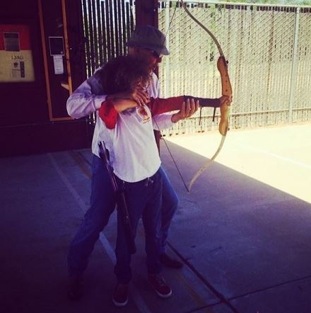 Armani Jackson learning archery at his teenage