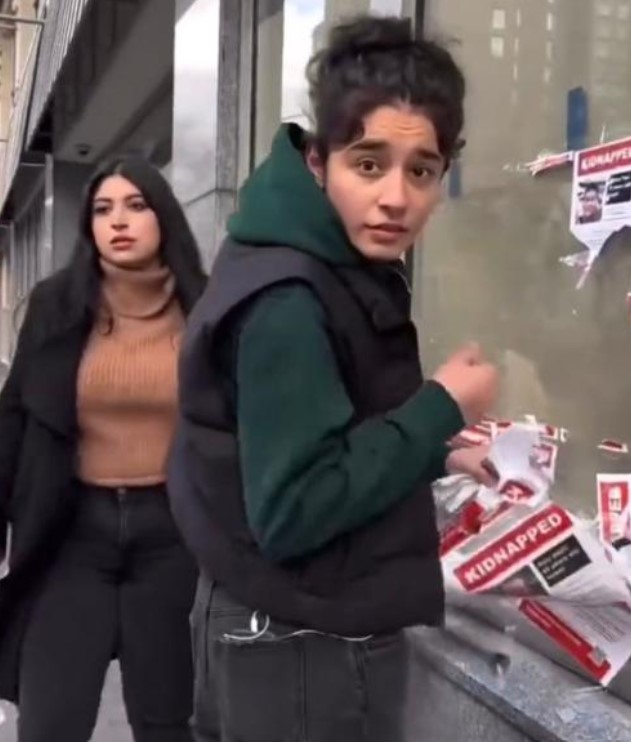 Marilyn Adler and her family confronted two individuals tearing down posters depicting Israeli child hostages